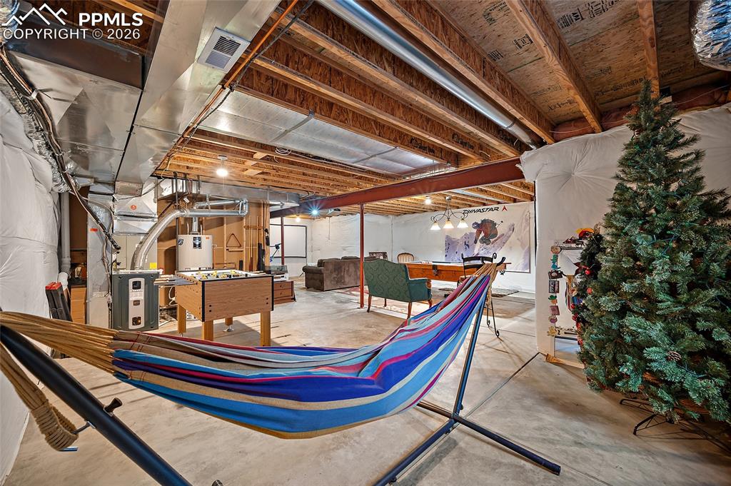 Image 42 of 49: Unfinished basement that is plumbed for a bath.  