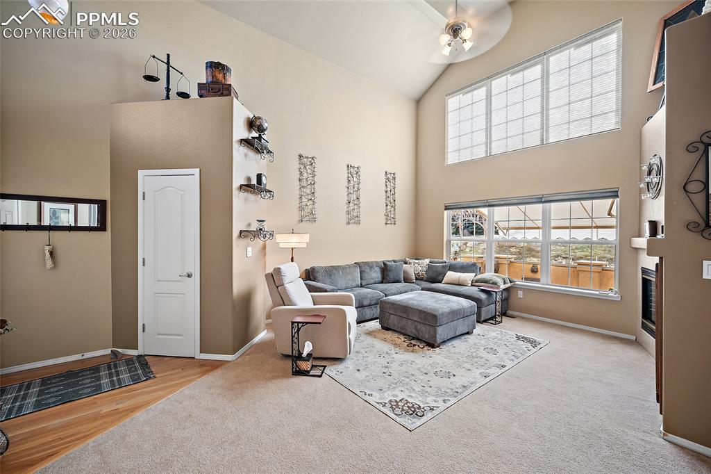 Image 7 of 50: Living room with wall of windows that allow plenty of natural light. Upper