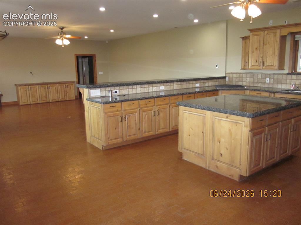 Image 12 of 34: Living room with brick floor, storage for entertainment area and a gas fire