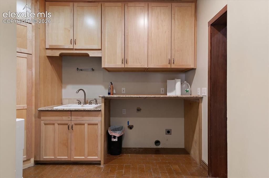 Image 25 of 50: 6 ft. X 10 ft. Laundry room with cabinets, folding table and deep utility s