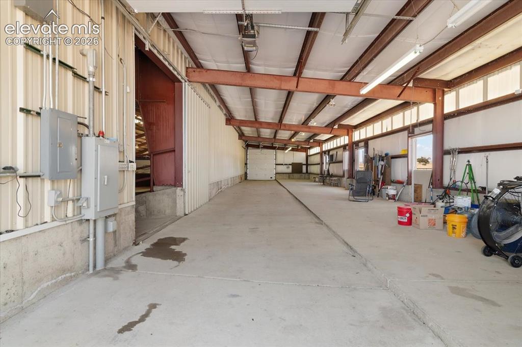 Image 28 of 50: Horse stall area measures 24 ft. X 100 ft. Overhead door on each end of thi