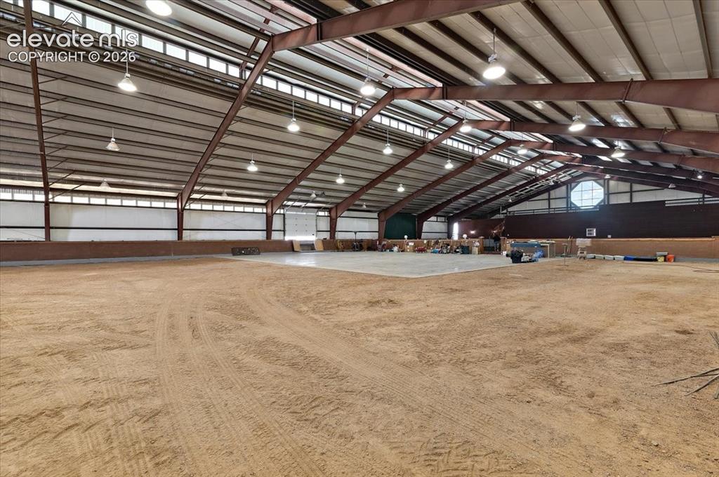 Image 38 of 50: Dirt arena area looking toward the tennis court and loft area. There are 40