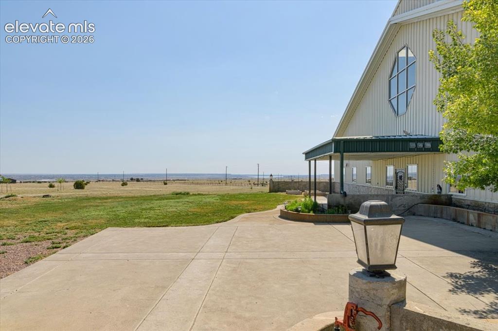 Image 44 of 50: Large concrete pad and covered entrance