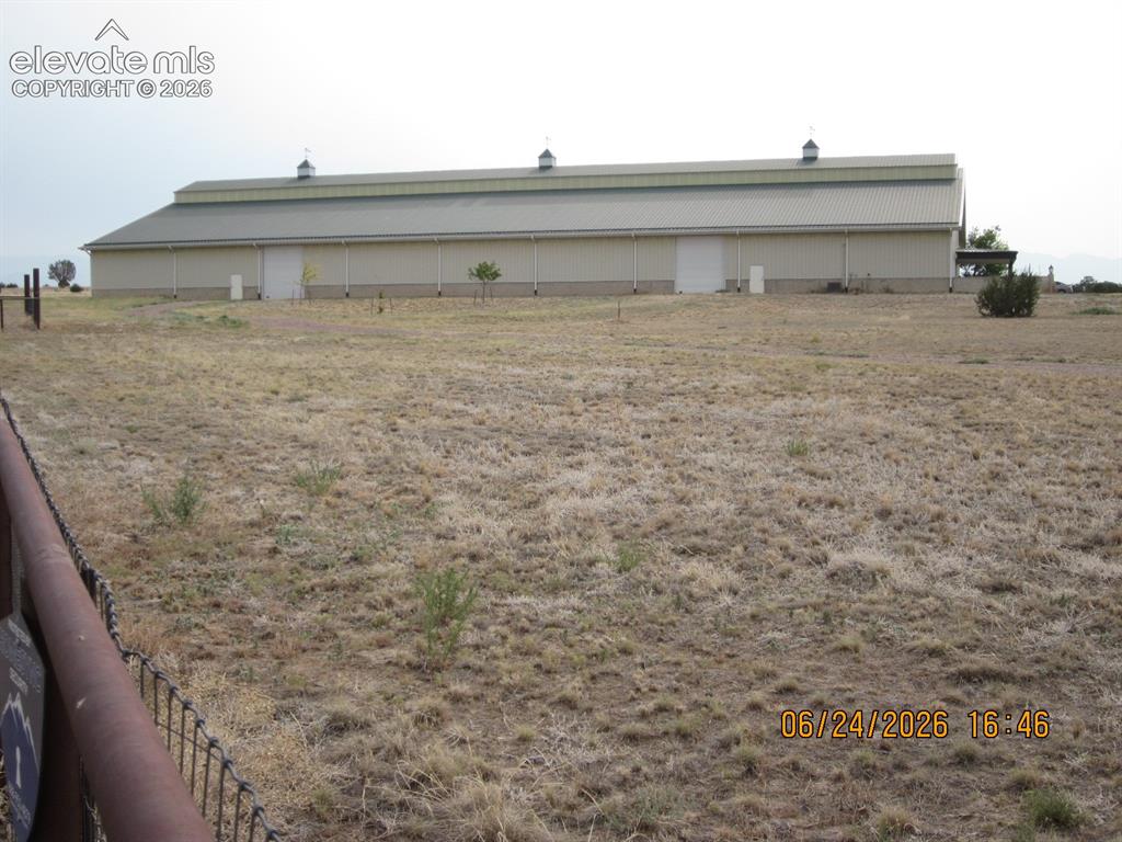 Image 6 of 34: West side of the building with 4 dutch doors leading out to the 72 ft. X 12