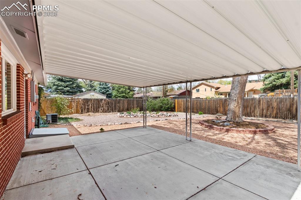 Image 23 of 34: Large covered patio perfect for entertainment