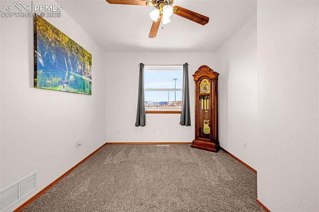 Image 14 of 42: Carpeted empty room with a ceiling fan and a textured wall