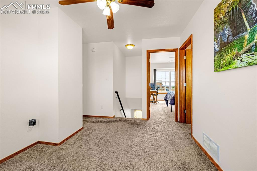 Image 16 of 42: Carpeted spare room with ceiling fan and baseboards
