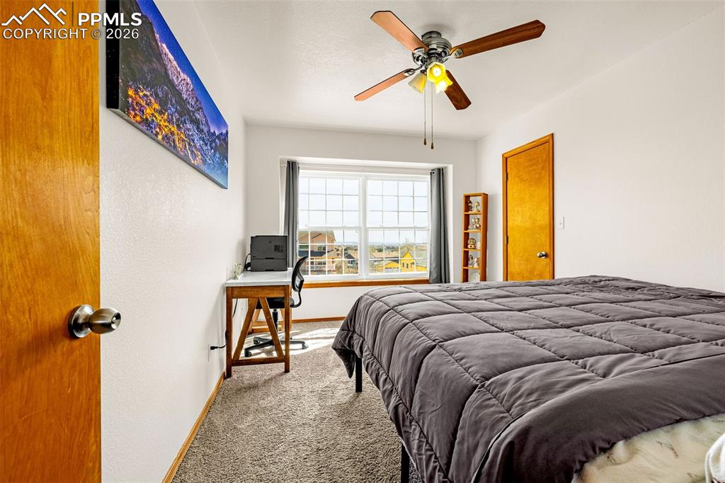 Image 17 of 42: Carpeted bedroom featuring baseboards and ceiling fan