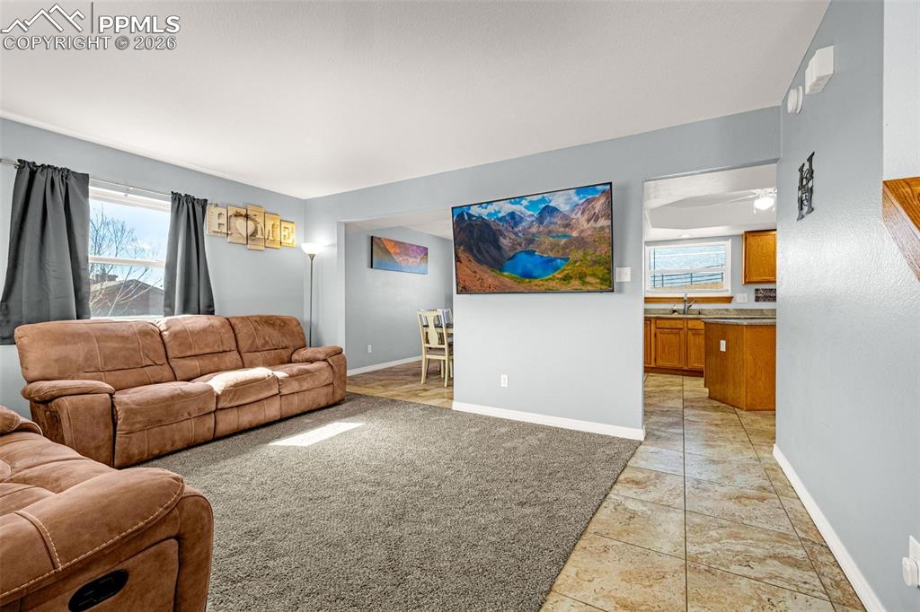 Image 4 of 42: Living area featuring baseboards and light tile patterned floors