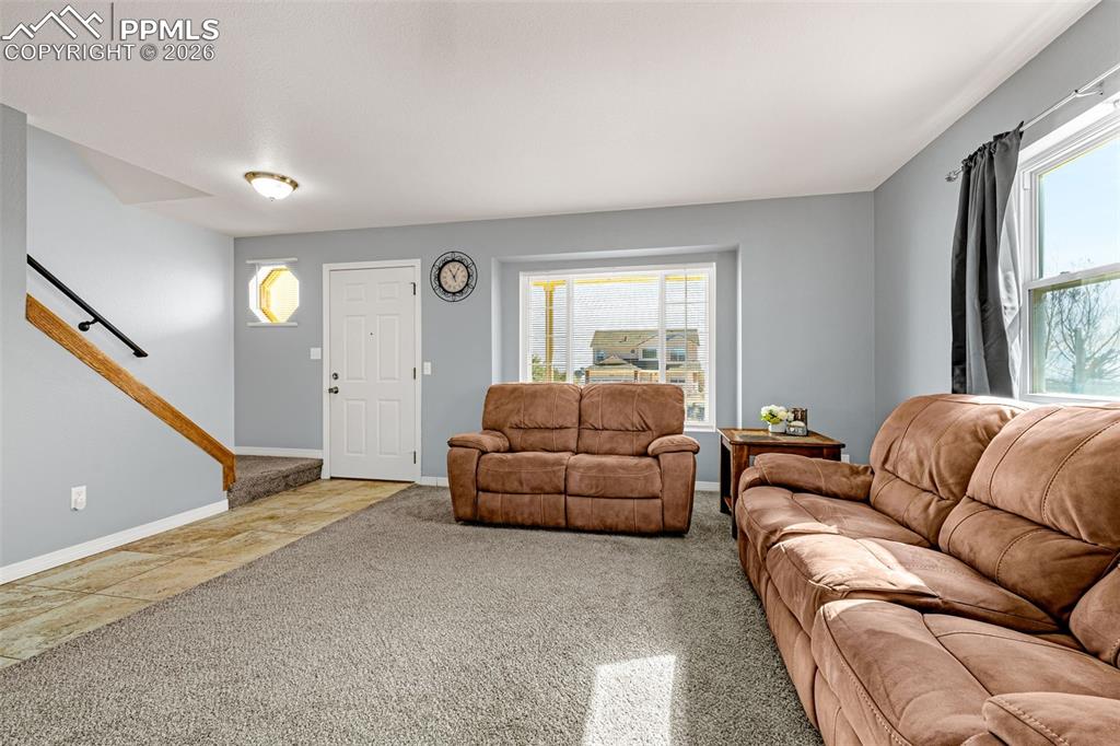 Image 5 of 42: Living area with carpet and baseboards