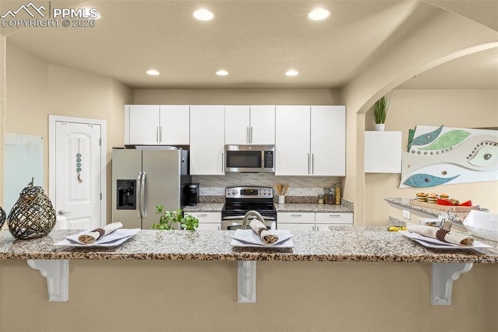 Image 17 of 50: Living room walks out to the back porch with mountain views