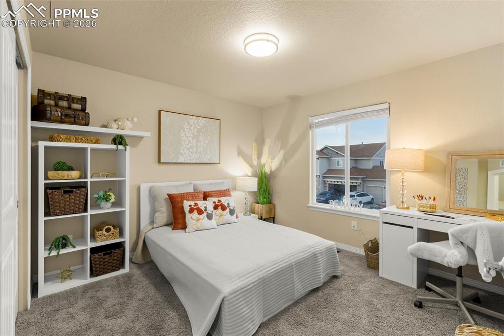 Image 26 of 50: Kitchen featuring white cabinets, stainless steel appliances, light stone c