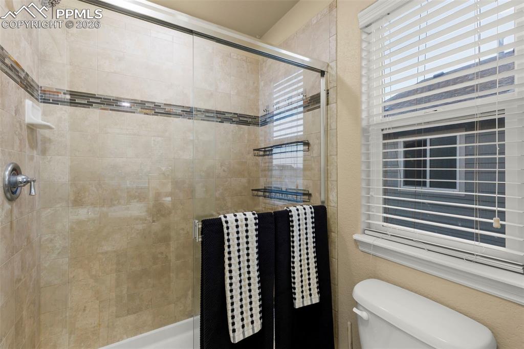 Image 35 of 50: Laundry room featuring a separate washer and dryer, and cabinet space
