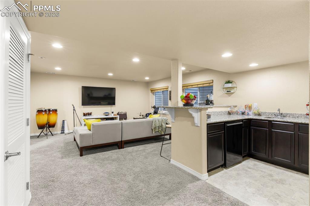 Image 38 of 50: Primary bedroom has ample space for a reading nook or TV area