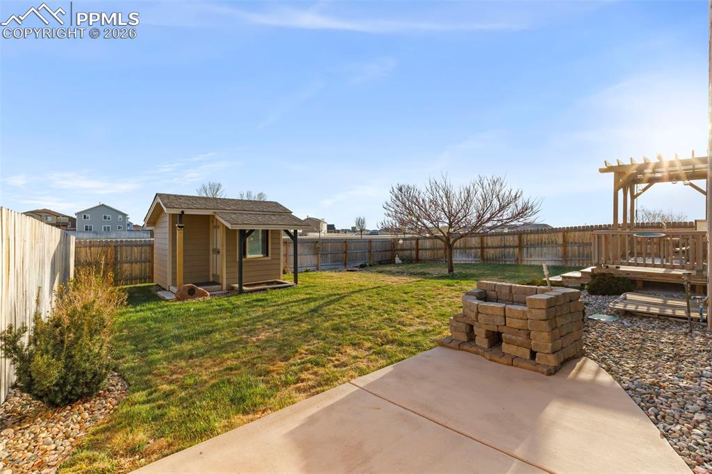 Image 46 of 50: Basement bar area with sink and beverage fridge 