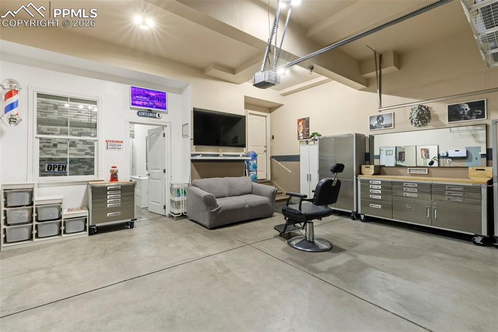 Image 48 of 50: Basement family room with a bar area