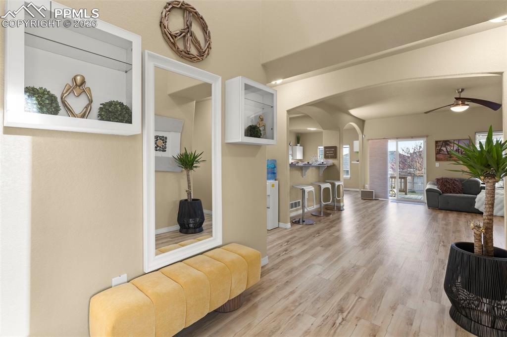 Image 5 of 50: Craftsman-style home with a gate, stone siding, driveway, and a garage