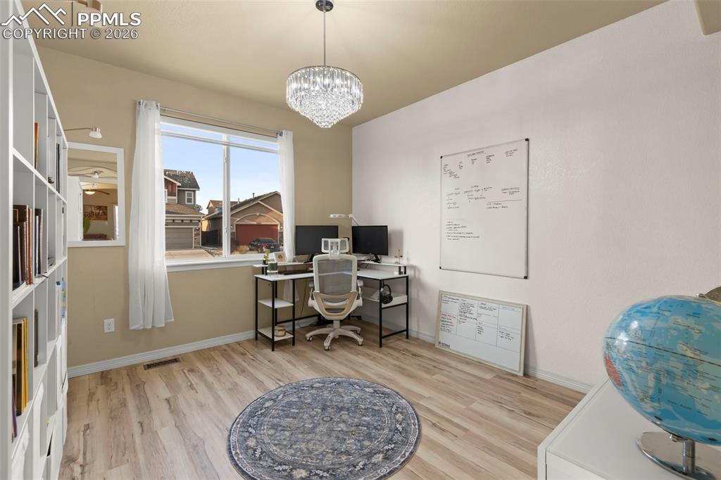 Image 7 of 50: Covered porch with a residential view