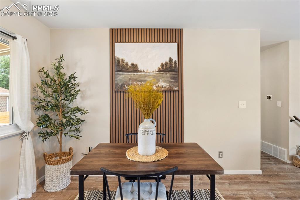 Image 12 of 38: Dining space featuring wood finished floors and baseboards