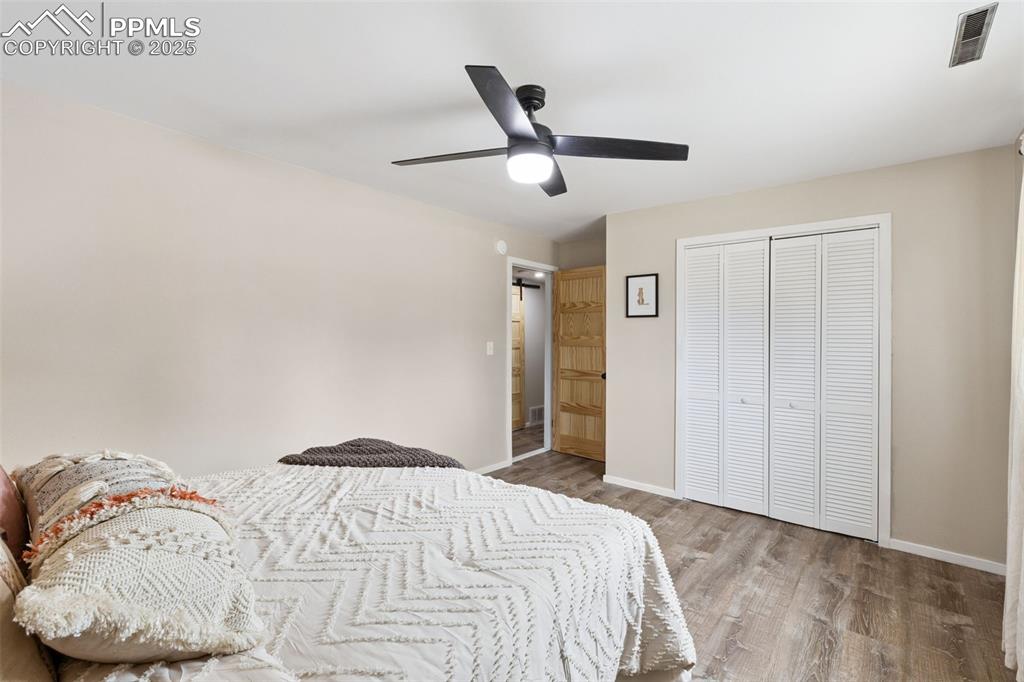 Image 29 of 38: Bedroom featuring wood finished floors, a closet, and a ceiling fan