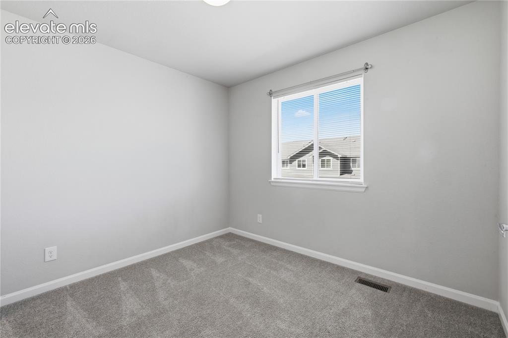 Image 33 of 42: Bright room featuring a double-paned window with horizontal blinds, neutral