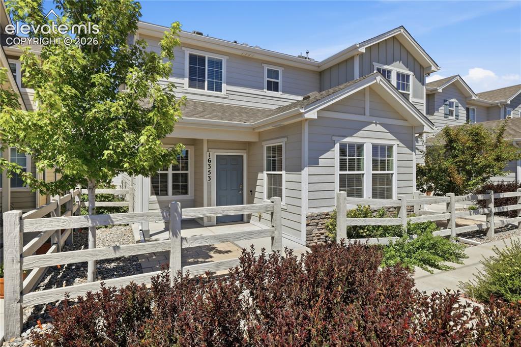 Image 38 of 42: Light gray siding exterior with stone accenting