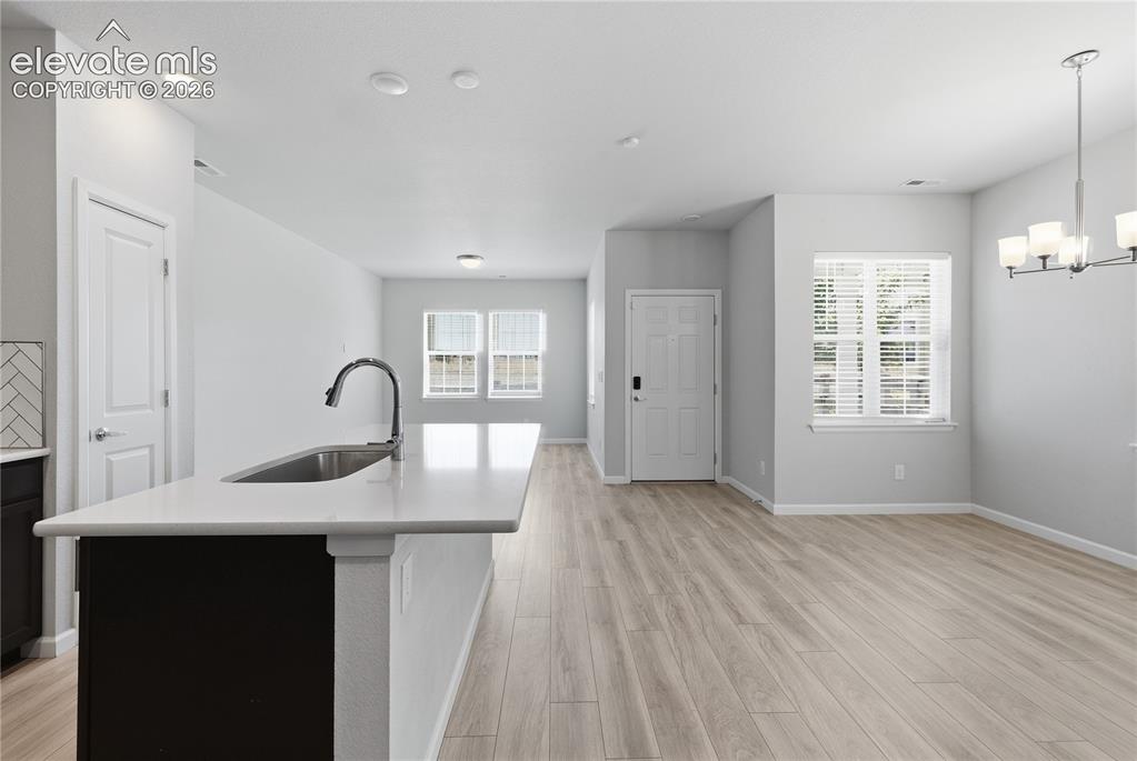 Image 6 of 42: Open-concept living area featuring light wood-finish flooring, recessed lig