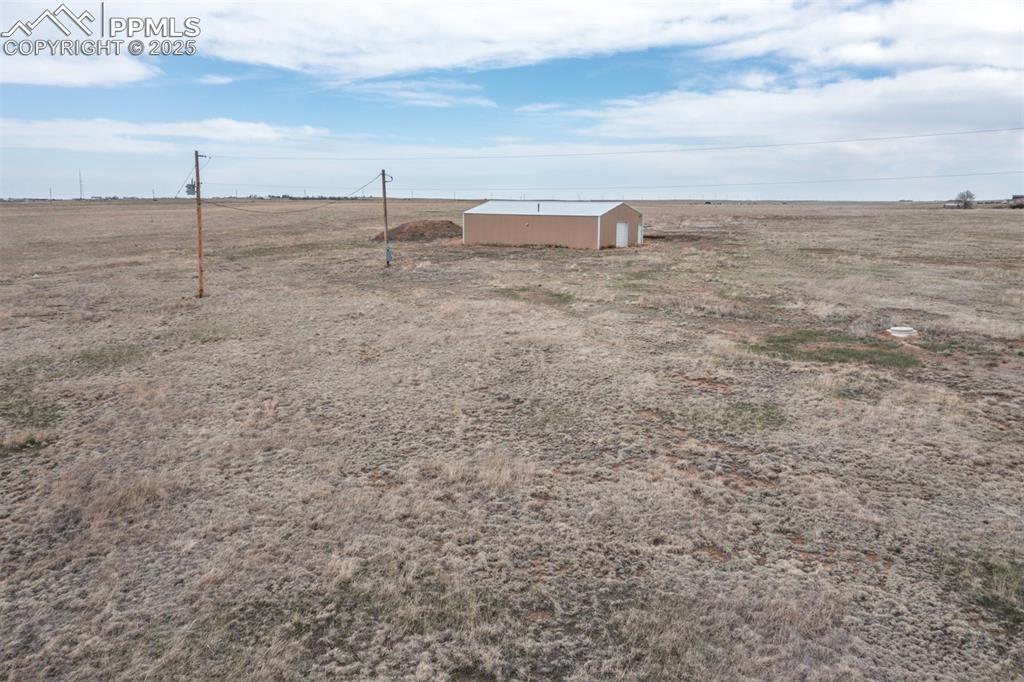 Image 28 of 30: View of 30 x 50 barn/garage/workshop and eclectic poles