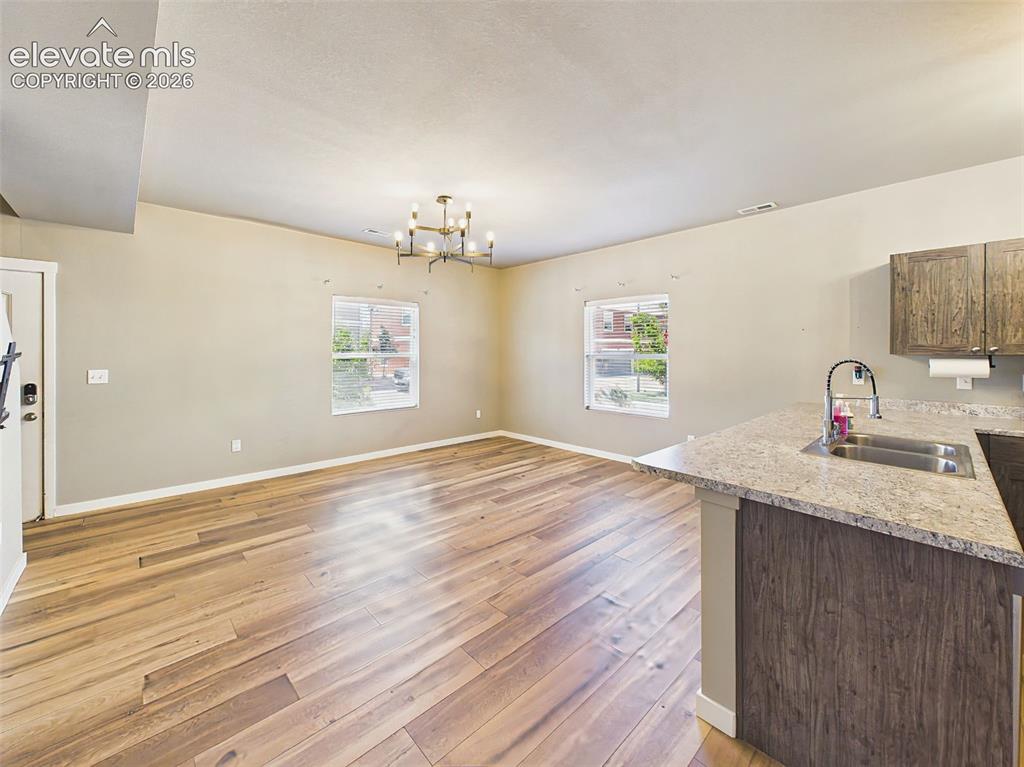 Image 10 of 40: Open-concept main level featuring brand-new flooring, fresh interior paint,