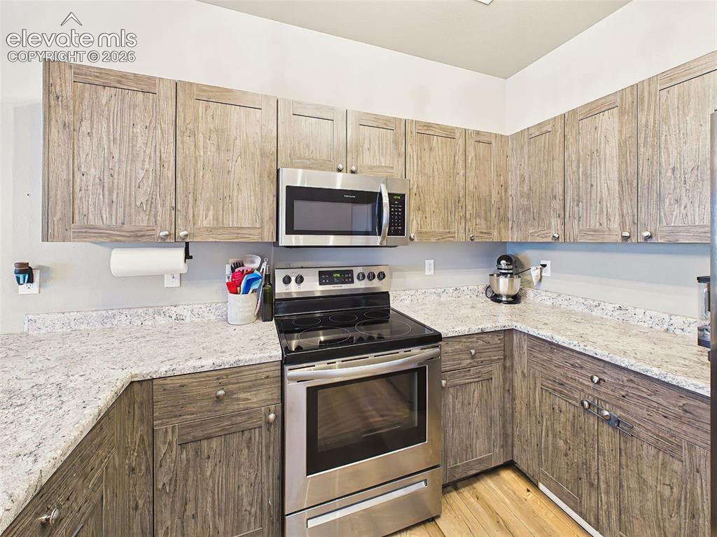 Image 13 of 40: Well-appointed kitchen featuring stainless steel appliances, abundant cabin