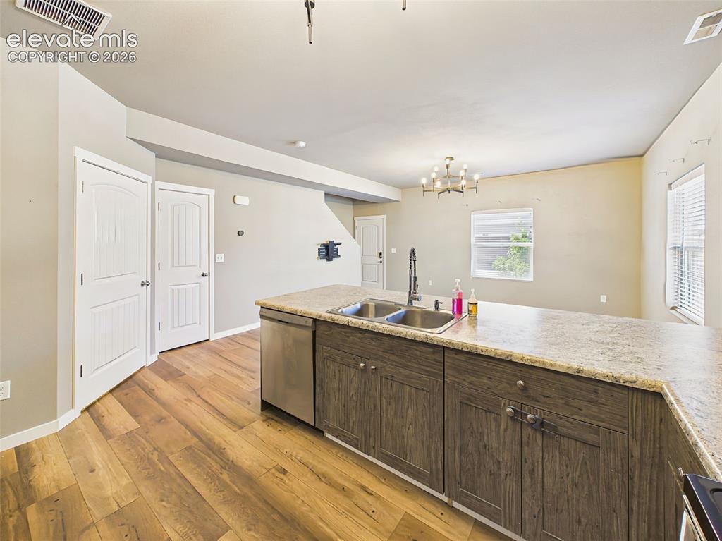 Image 14 of 40: Oversized kitchen island with double-basin sink, dishwasher, and ample work
