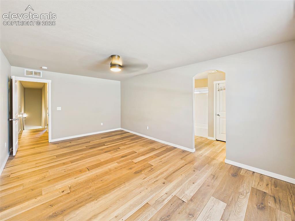 Image 18 of 40: Large primary bedroom with abundant space for a king-size furniture arrange