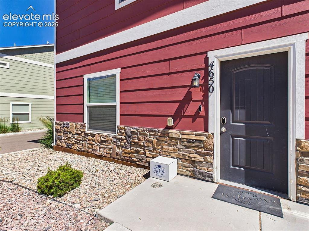 Image 2 of 40: Private front entrance with low-maintenance landscaping and attractive exte