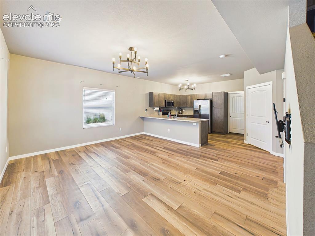 Image 3 of 40: Expansive main-level living area with fresh paint, updated flooring, and an