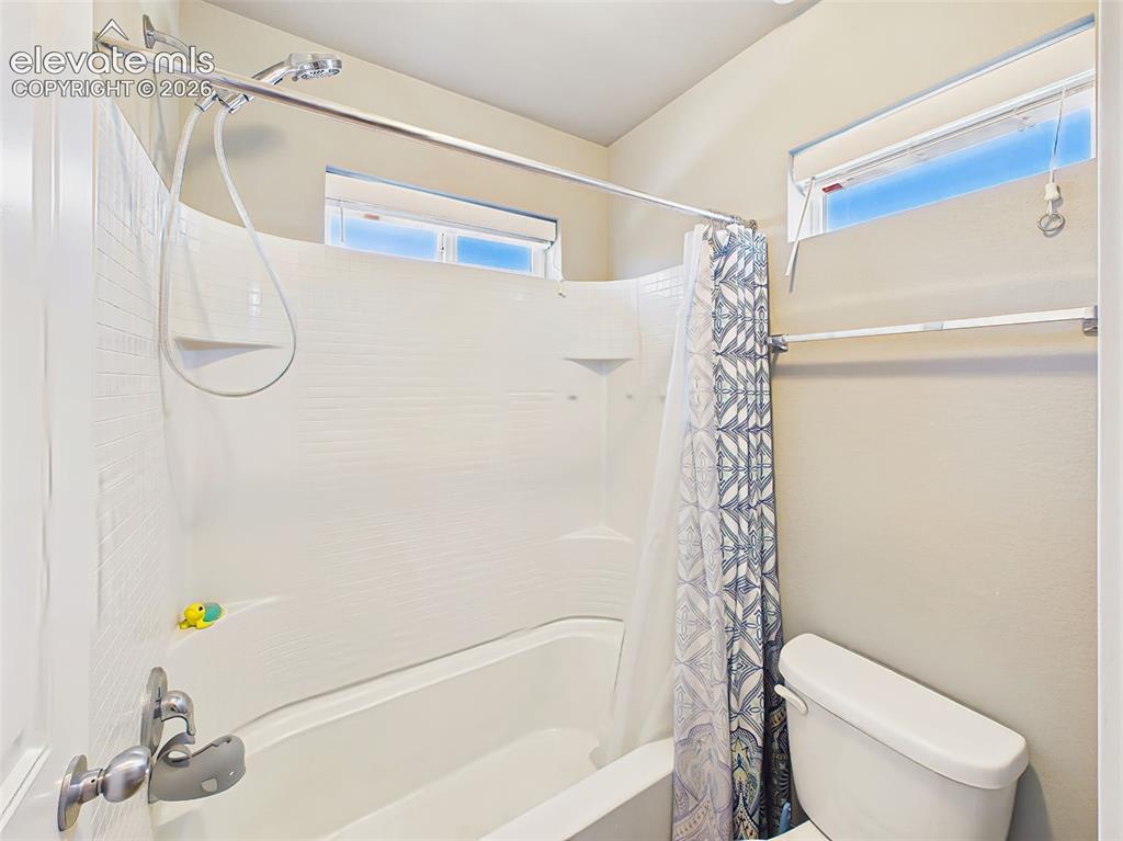 Image 30 of 40: Full bathroom with tub/shower combination, modern fixtures, and natural lig