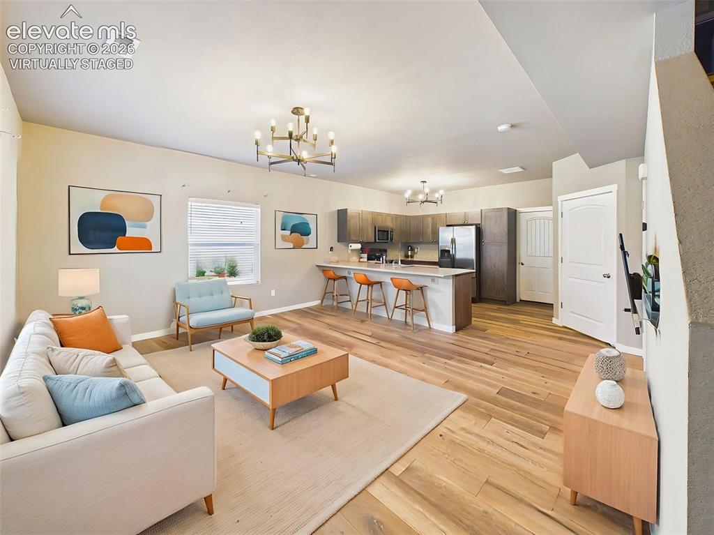 Image 4 of 40: (Virtually Staged) Open-concept living and dining area featuring a breakfas