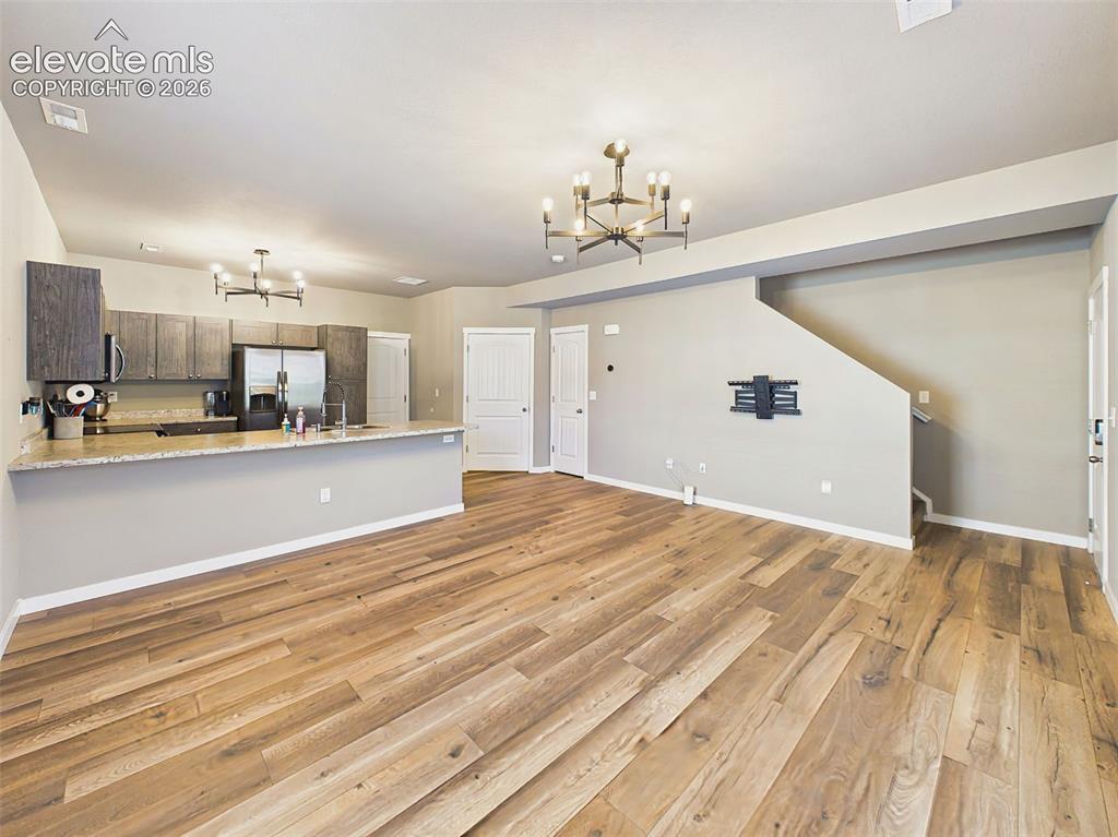 Image 5 of 40: Large open living area with direct sightlines to the kitchen, creating a fu