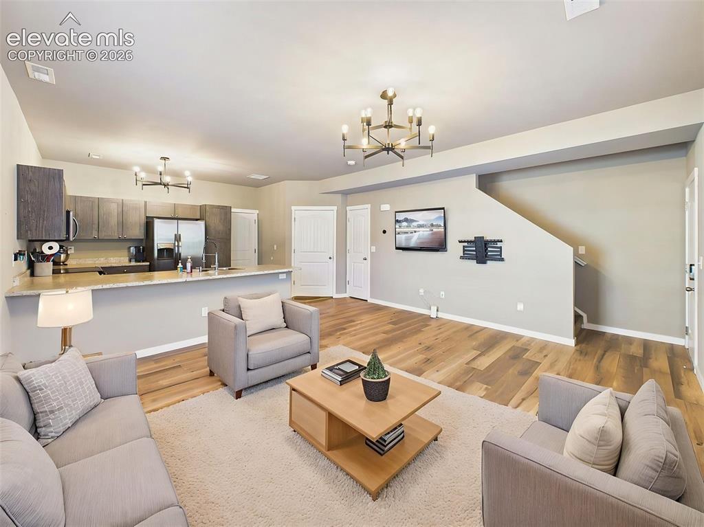 Image 6 of 40: Large open living area with direct sightlines to the kitchen, creating a fu