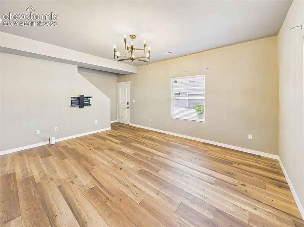 Image 7 of 40: Bright and spacious living area with durable flooring, neutral colors, and 