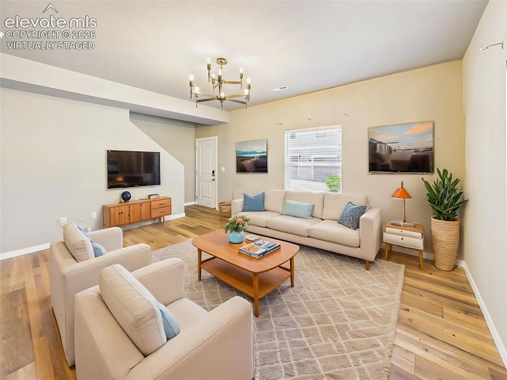 Image 8 of 40: (Virtually Staged) Inviting living room showcasing the open-concept design,