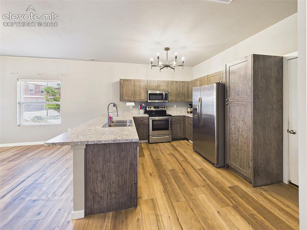Image 9 of 40: Spacious kitchen offering stainless steel appliances, abundant cabinet stor
