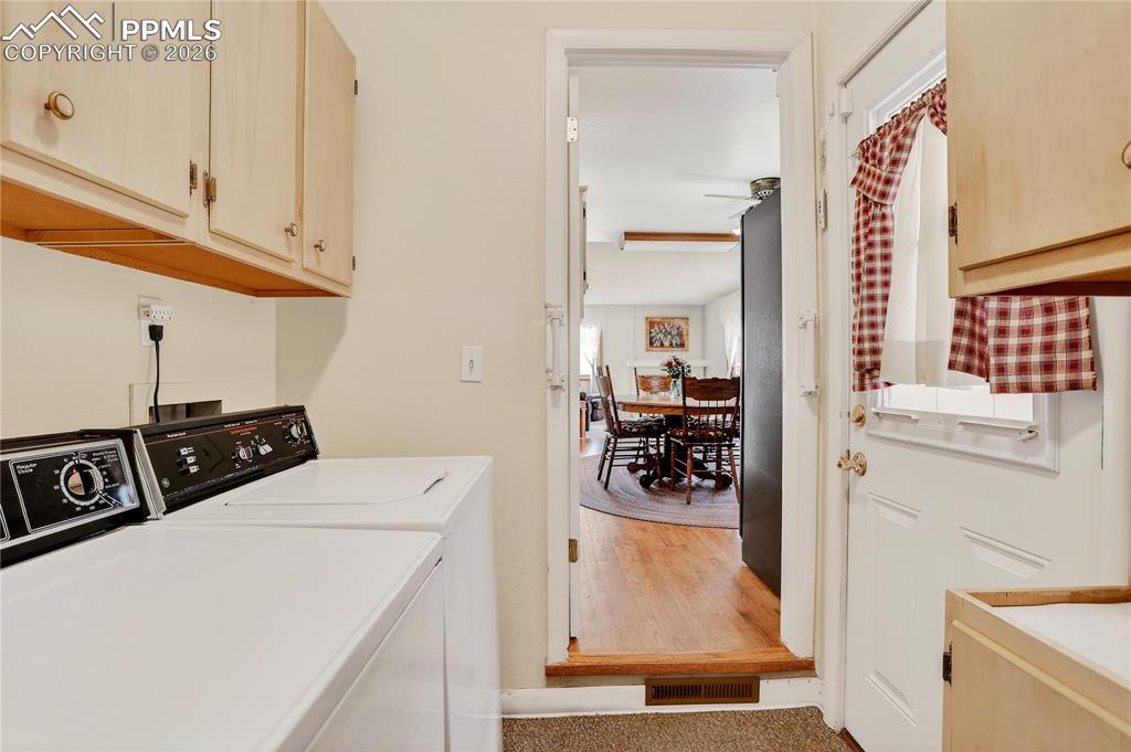 Image 16 of 37: Main floor laundry. Door on the right leads to the patio with Sunsetter awn