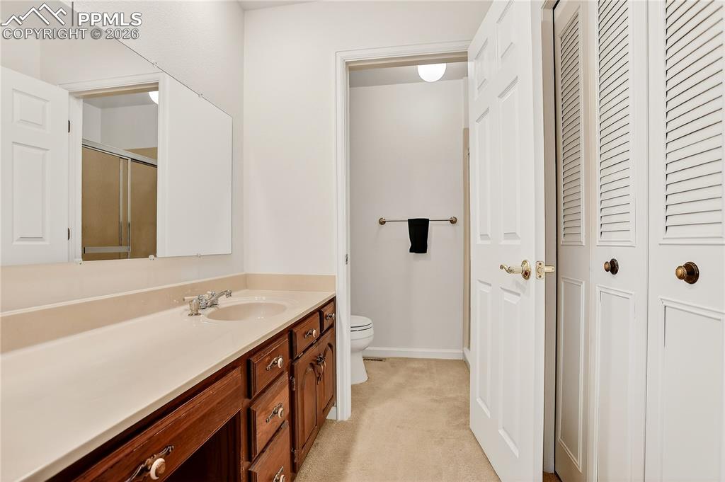 Image 23 of 37: Primary bathroom has plenty of storage and a walk-in shower.