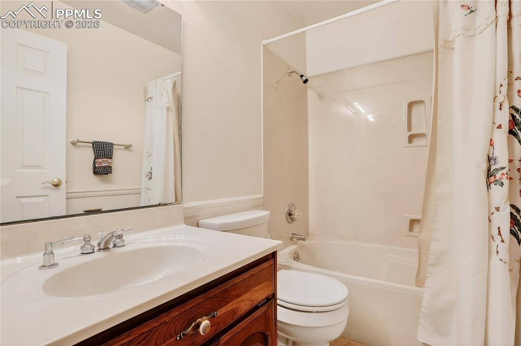 Image 27 of 37: Upper level full bath with tub & shower