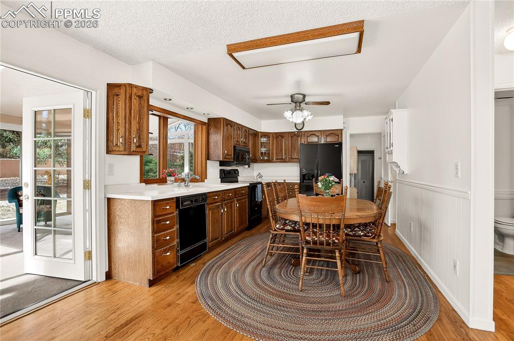 Image 9 of 37: Kitchen with oak cabinets and wood floors -- all appliances convey!