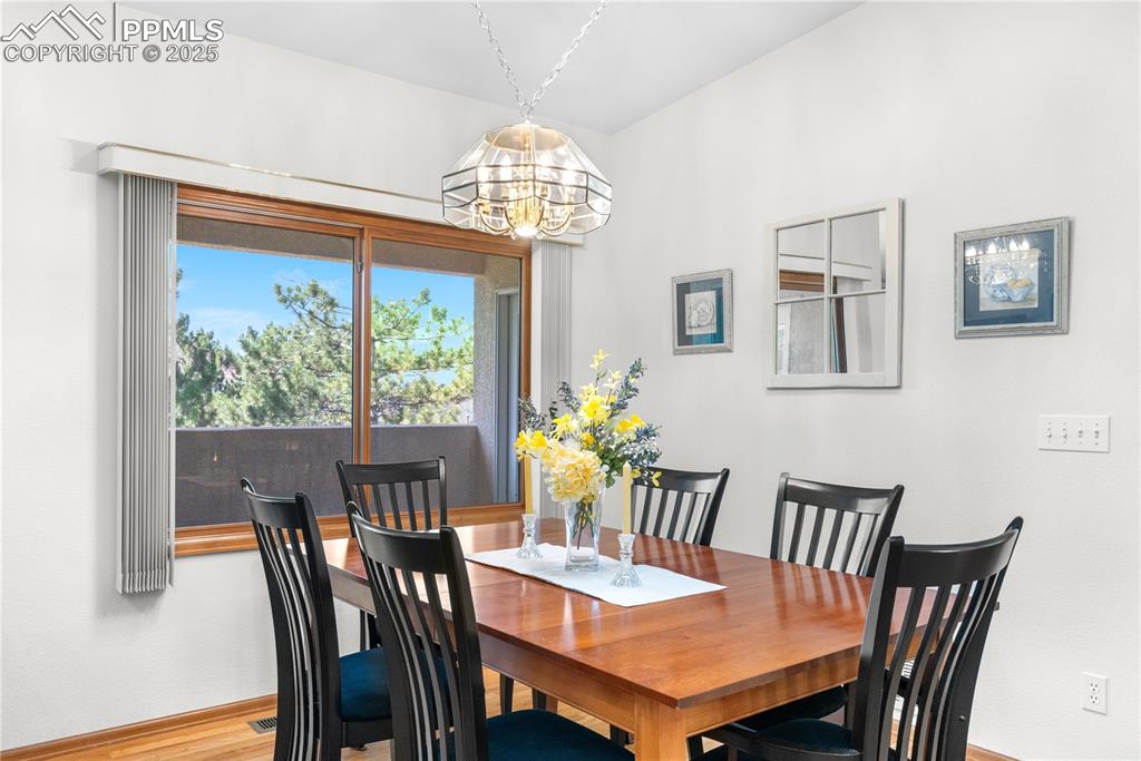 Image 12 of 49: Dining space with a chandelier and baseboards