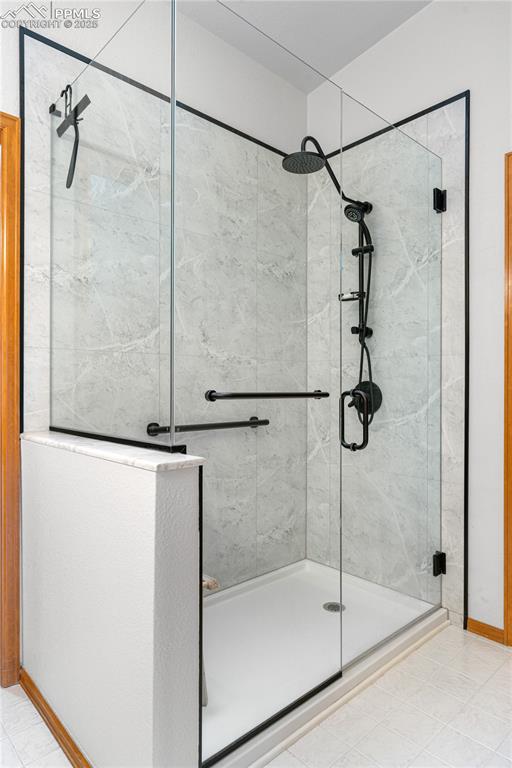 Image 27 of 49: Full bath with a shower stall