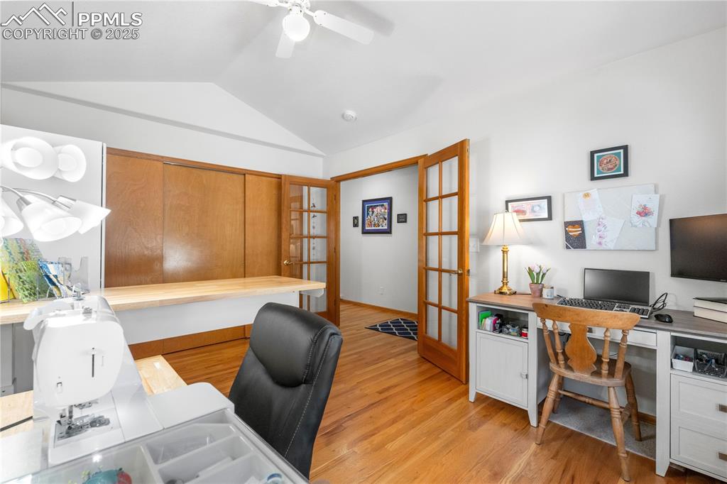Image 3 of 49: Home office featuring french doors, lofted ceiling, light wood-type floorin