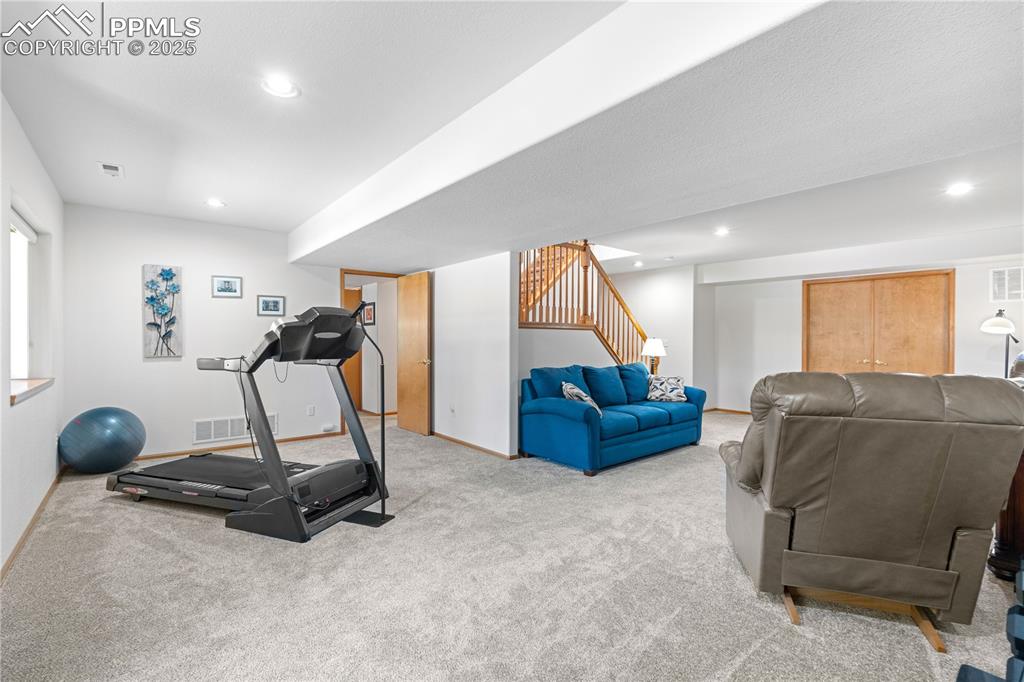 Image 30 of 49: Exercise area featuring light carpet and recessed lighting