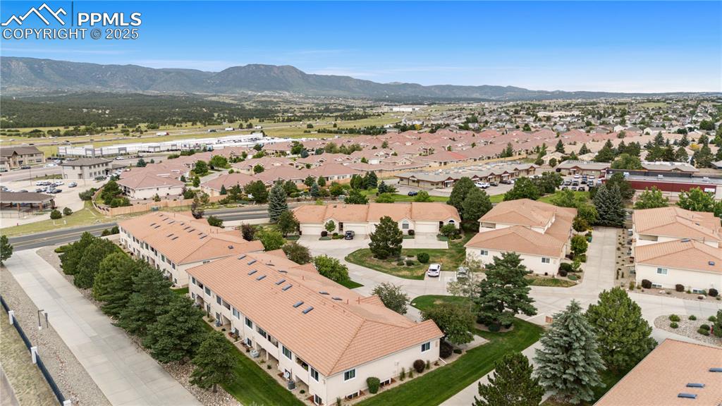 Image 45 of 49: Aerial perspective of suburban area with a mountainous background